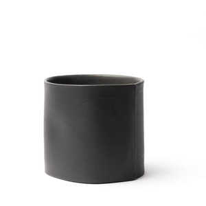 Black tumbler made by OXUM NYC, part of the handmade ceramic home accessories collection. Perfect for wine, spirits, and those fancy on-the-rock drinks. With a signature seam that screams, "I'm special, la la la." And don't forget about its thumb dimple, which is perfect for a comfy hold. The matte exterior adds a touch of earthiness, The glossy glaze shines like a superstar.
