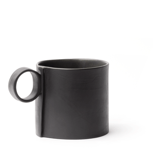 Black mug made by OXUM NYC, part of the handmade ceramic home accessories collection. With its signature seam, cute dimples, a glossy glaze interior, and a matte exterior. It is a sight to behold!