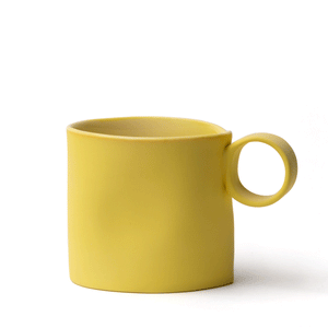 Yellow big mug made by OXUM NYC, part of the handmade ceramic home accessories collection. Perfect for wine, spirits, and those fancy on-the-rock drinks. With a signature seam that screams, "I'm special, la la la." And don't forget about its thumb dimple, which is perfect for a comfy hold. The matte exterior adds a touch of earthiness, The glossy glaze shines like a superstar.